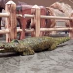 A wooden crocodile up for sale