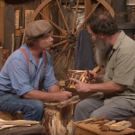 A screen grab from "The Woodwright's Shop Season 31, Episode 8, featuring Peter Follansbee showing Roy Underhill how to carve a Swedish-style spoon.