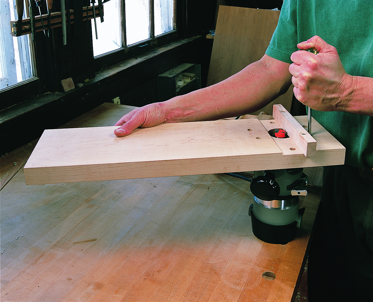 Make perfectly flush joints on large pieces of edged plywood with this portable router jig.