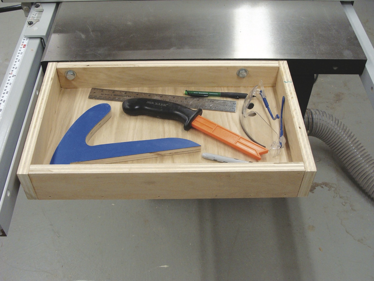 A storage tray is a useful addition to any stationary tool. Add a table saw tray to your shop to keep tools handy, yet out of the way.