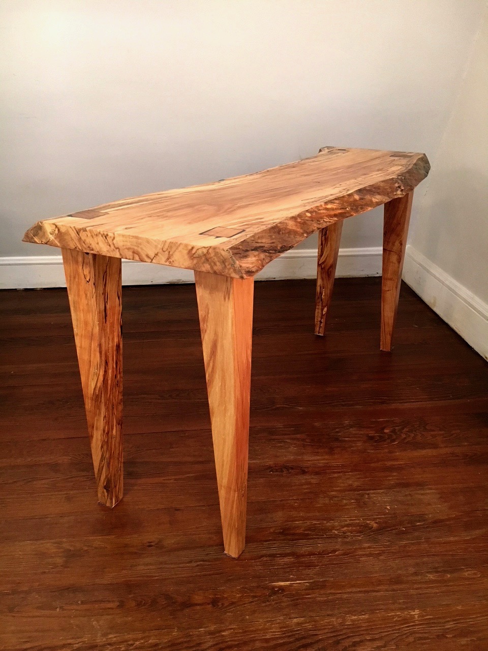 Yoav Liberman and his student Lisa put the finishing touches on a unique live edge desk.