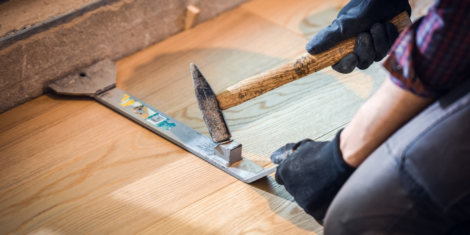 Carpenter installing hardwood floor