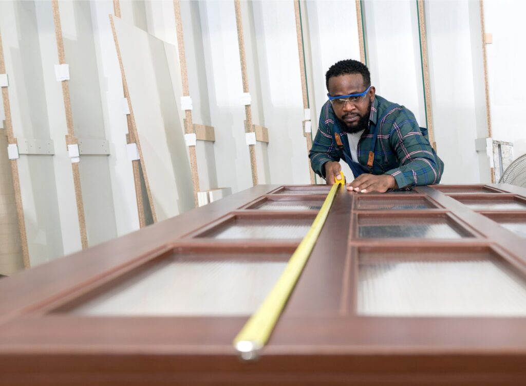 Man measuring a wooden door