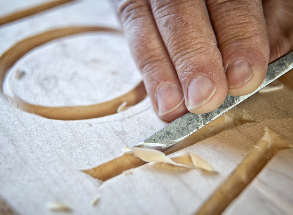 Woodworking craftsman engraving wood