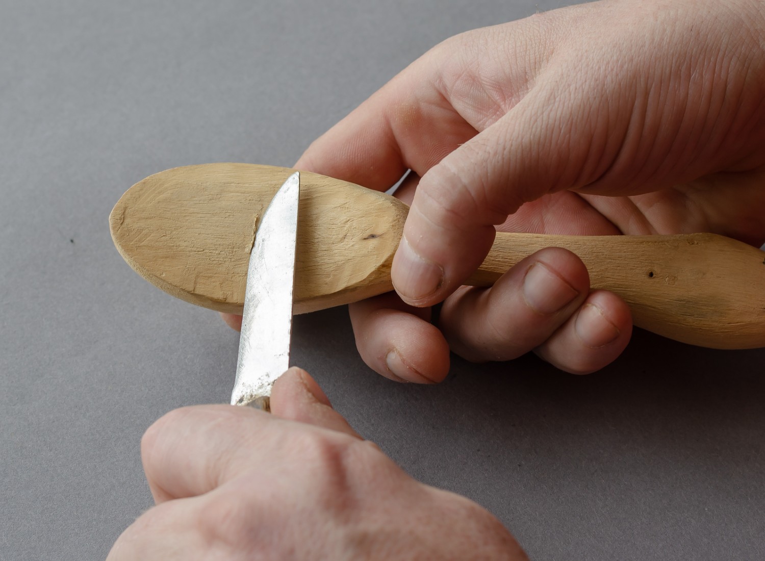 Man carving a wooden spoon