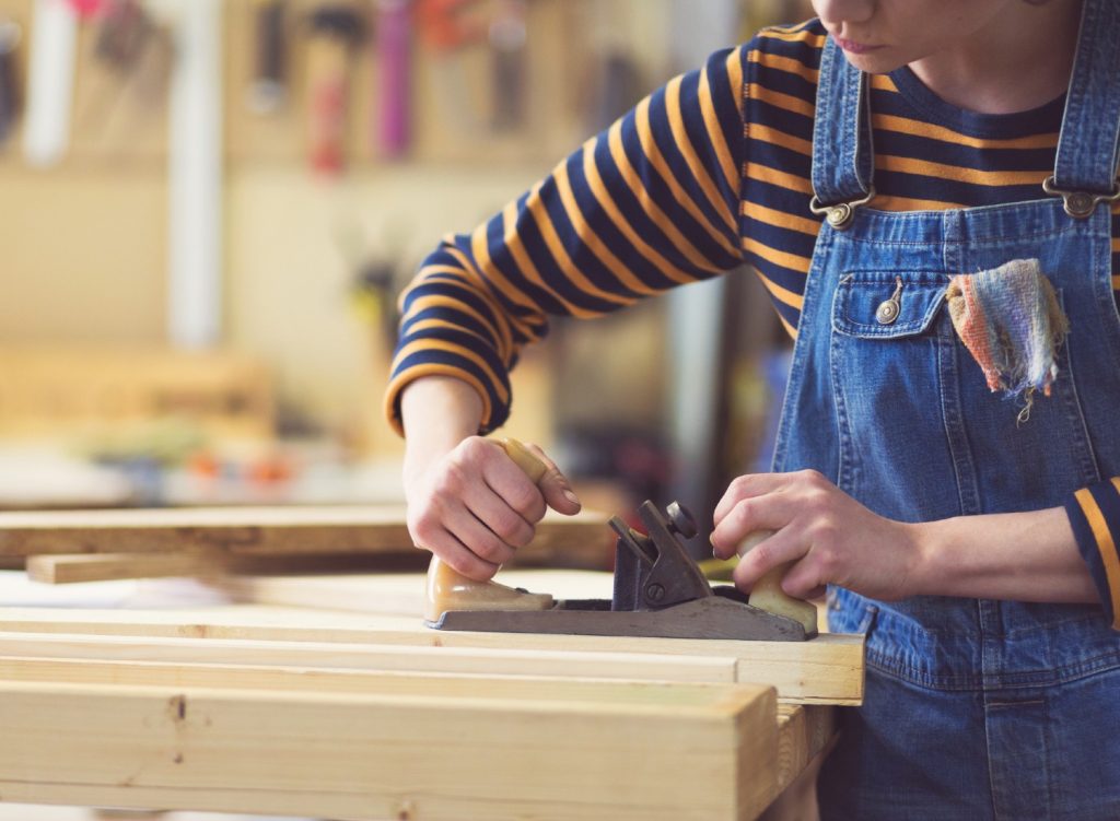 Woman using a wood jointer