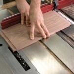 A fair amount of downward pressure ensures accuracy with this technique. If you don’t keep the board pressed down flat, it will try to rise up on you. Even a bit of this will result in a too-thick tenon. If you are not sure that you are holding the piece down firmly, make a second pass over the blades.