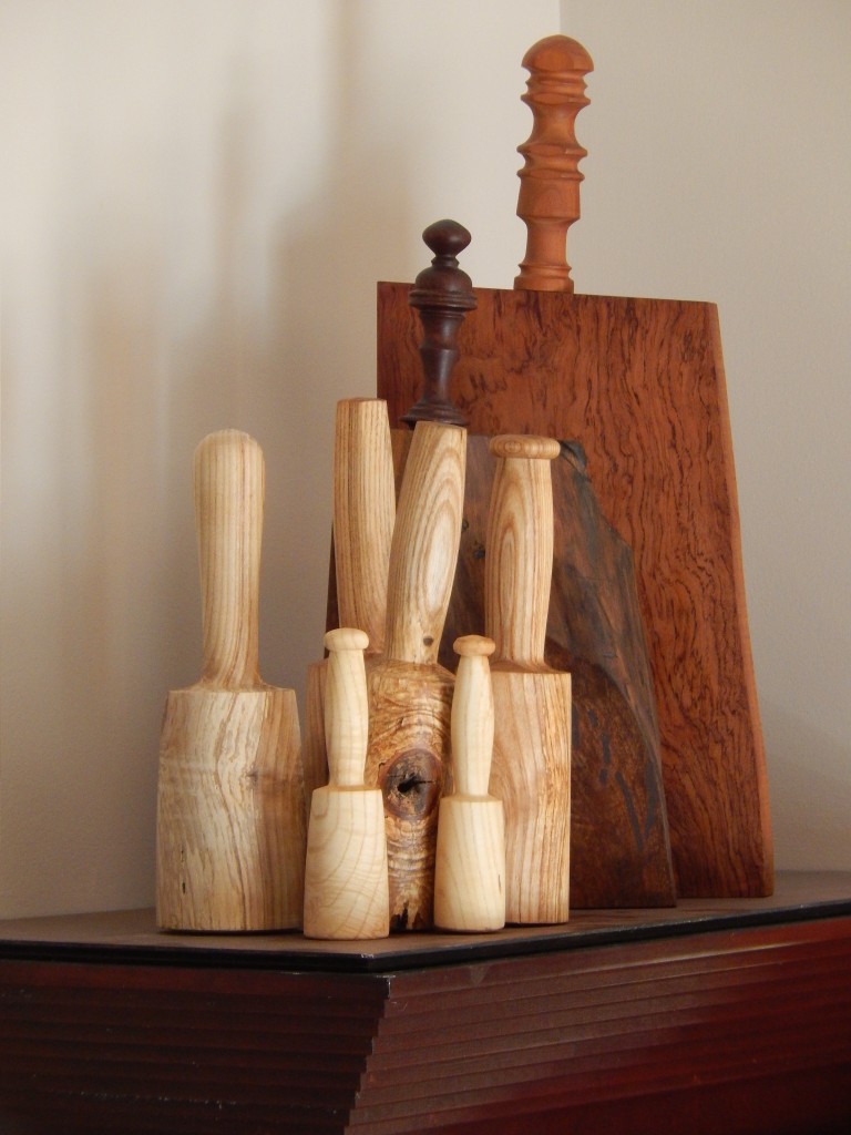 My "family" of mallets and two of my turned handle cutting boards  reside on top of our kitchen cabinets.