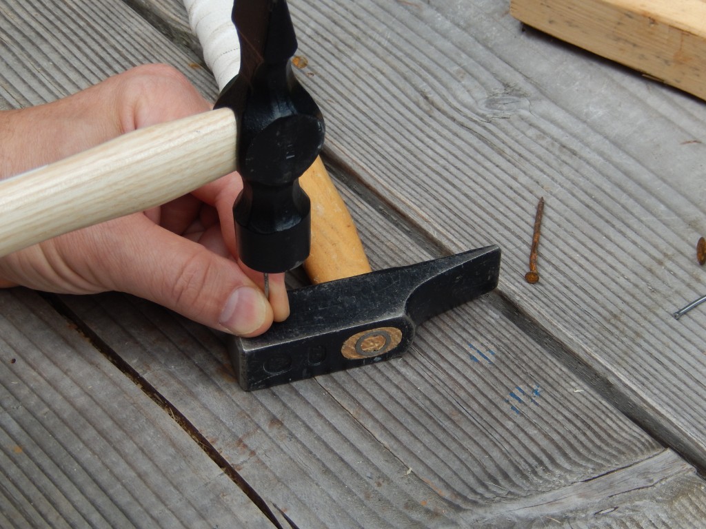 I use my French/German hammer as an anvil to compress the tip of a nail before driving it into the wood. This will ensure that the piece will not split 