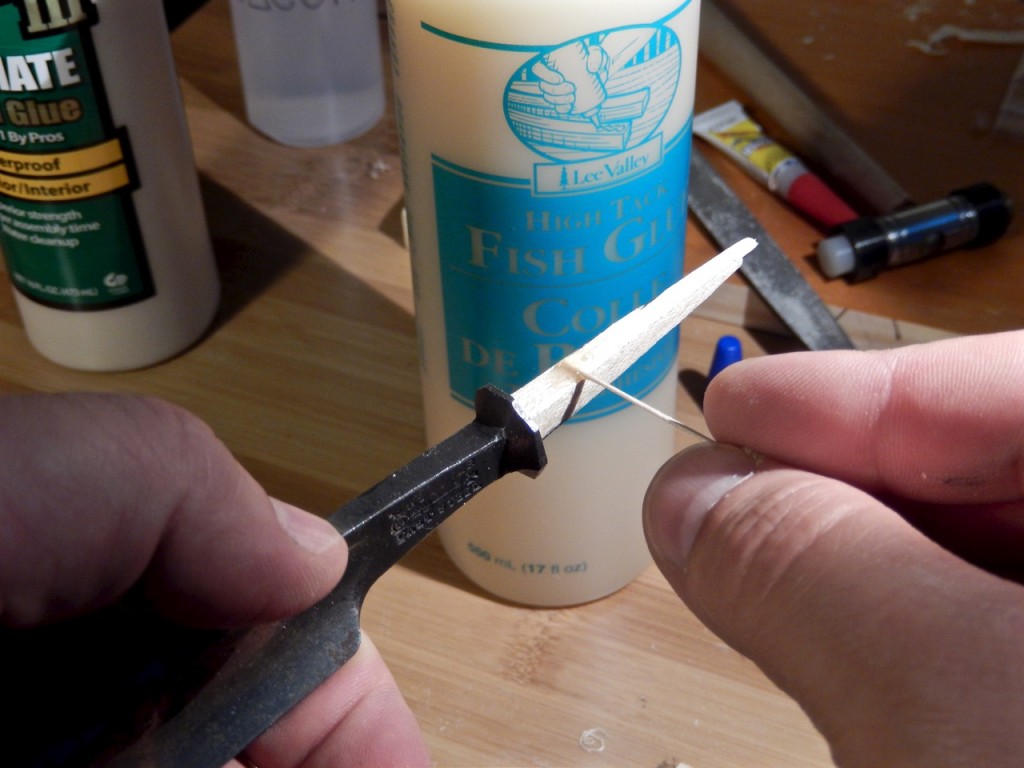 Spread some glue on the shims and with confidence drive the tang back home