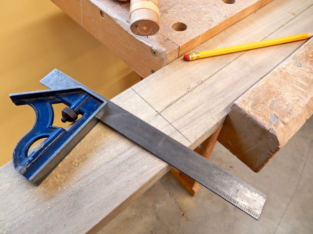 Marking the location of the first cross cut at the end of the rip cut that split the board in the middle. 