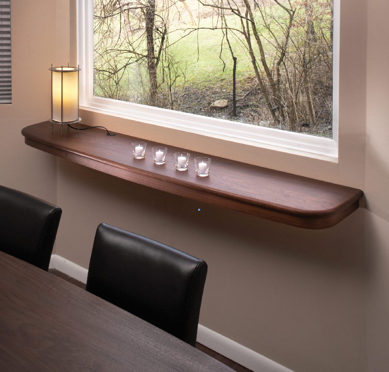 Created for a small space, this floating dining server is mounted on steel rods that are attached to the wall studs.