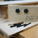 A clamping jig with a cloud lifted profile safely holds thin stock while at the router table.