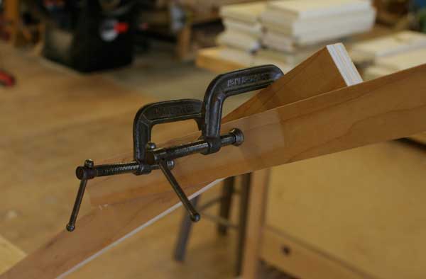 When the case is square, apply a second clamp to the brace to hold it in place while the assembly dries.