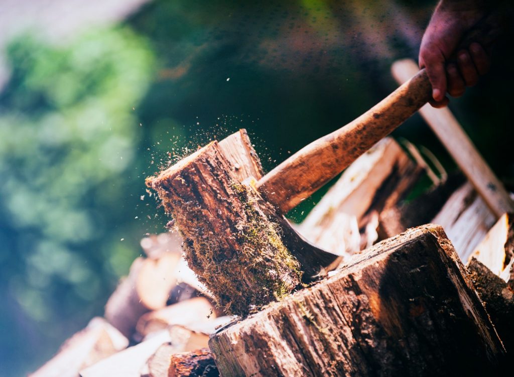 Person splitting wood with an axe