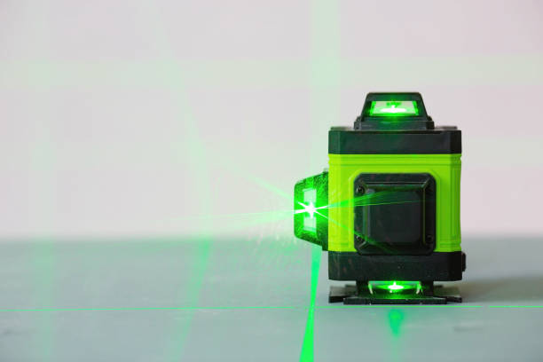 a small neon green laser level device on a table with a white background